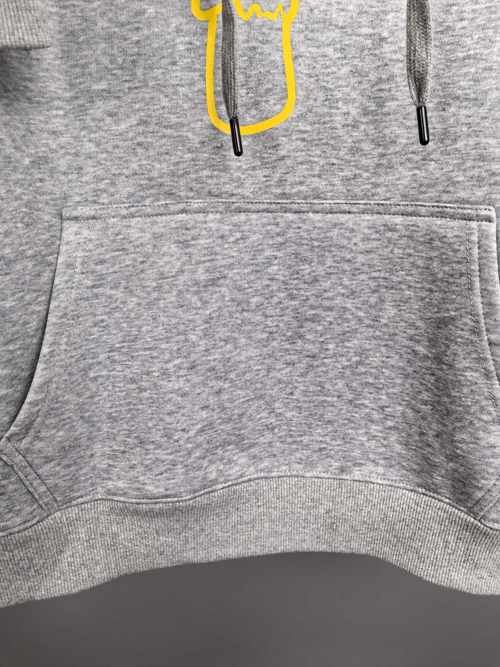 Gray hoodie front pocket and ribbed hem with drawstring ends
