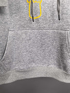 Gray hoodie front pocket and ribbed hem with drawstring ends