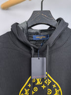 Louis Vuitton hooded sweatshirt neckline close-up with yellow graphic and brand tag