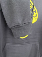 Dark gray sweatshirt sleeve cuff and front pocket seam detail