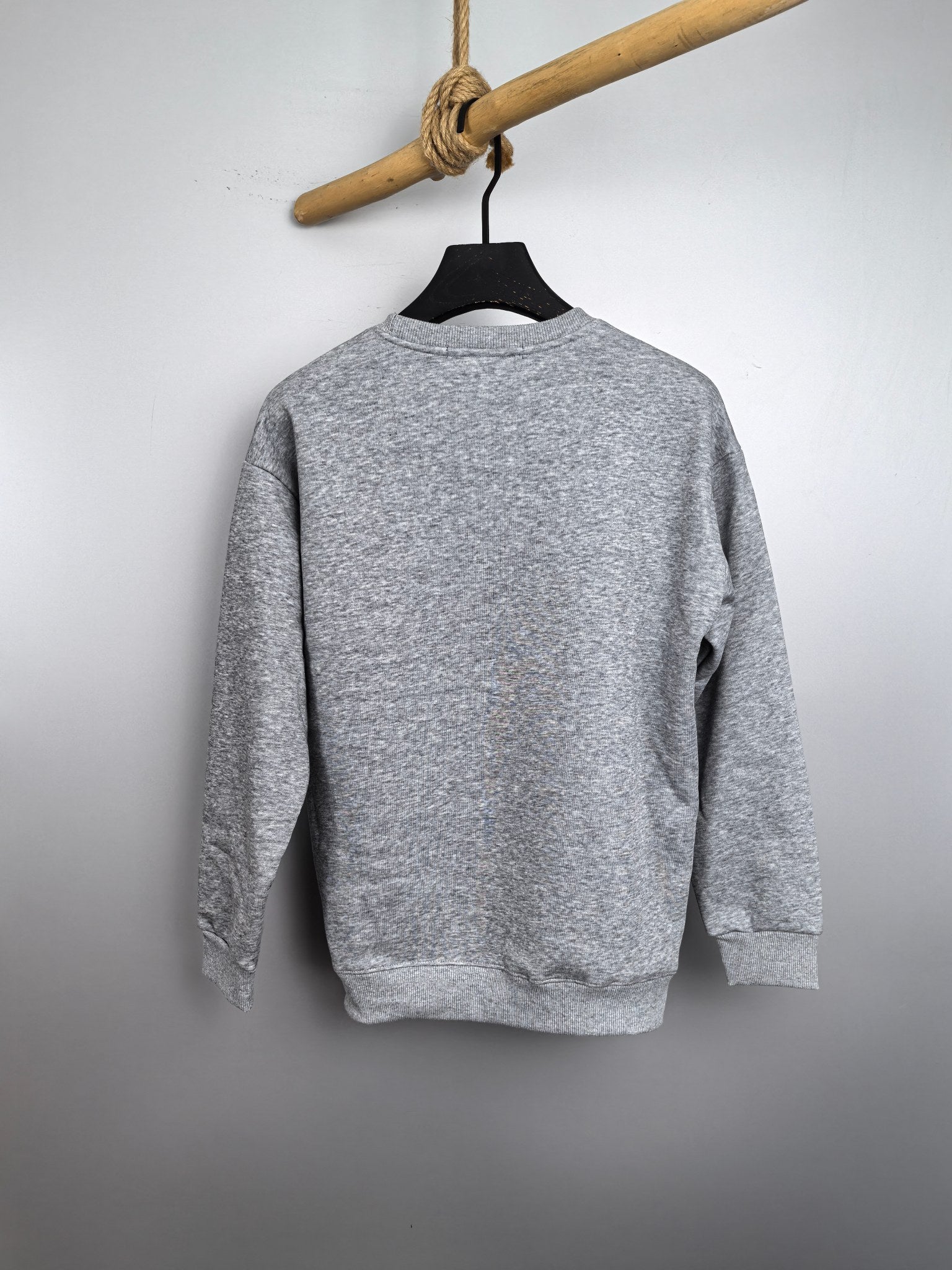 Heather gray long-sleeve sweatshirt shown from the back on a hanger