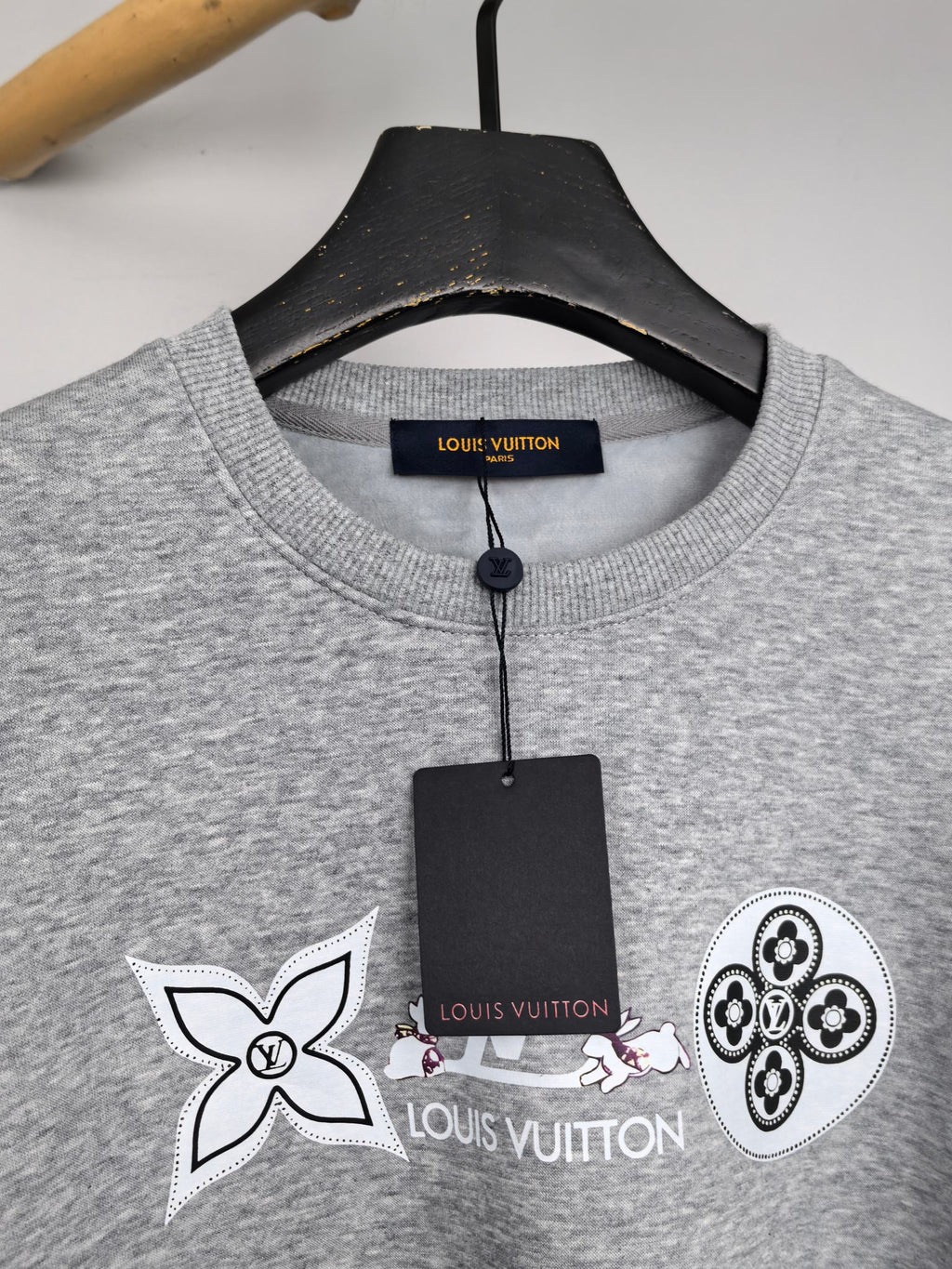 Heather gray sweatshirt collar with multicolor and black logo graphic detail