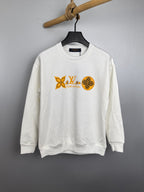 White crewneck sweatshirt with orange Louis Vuitton-style graphic on chest