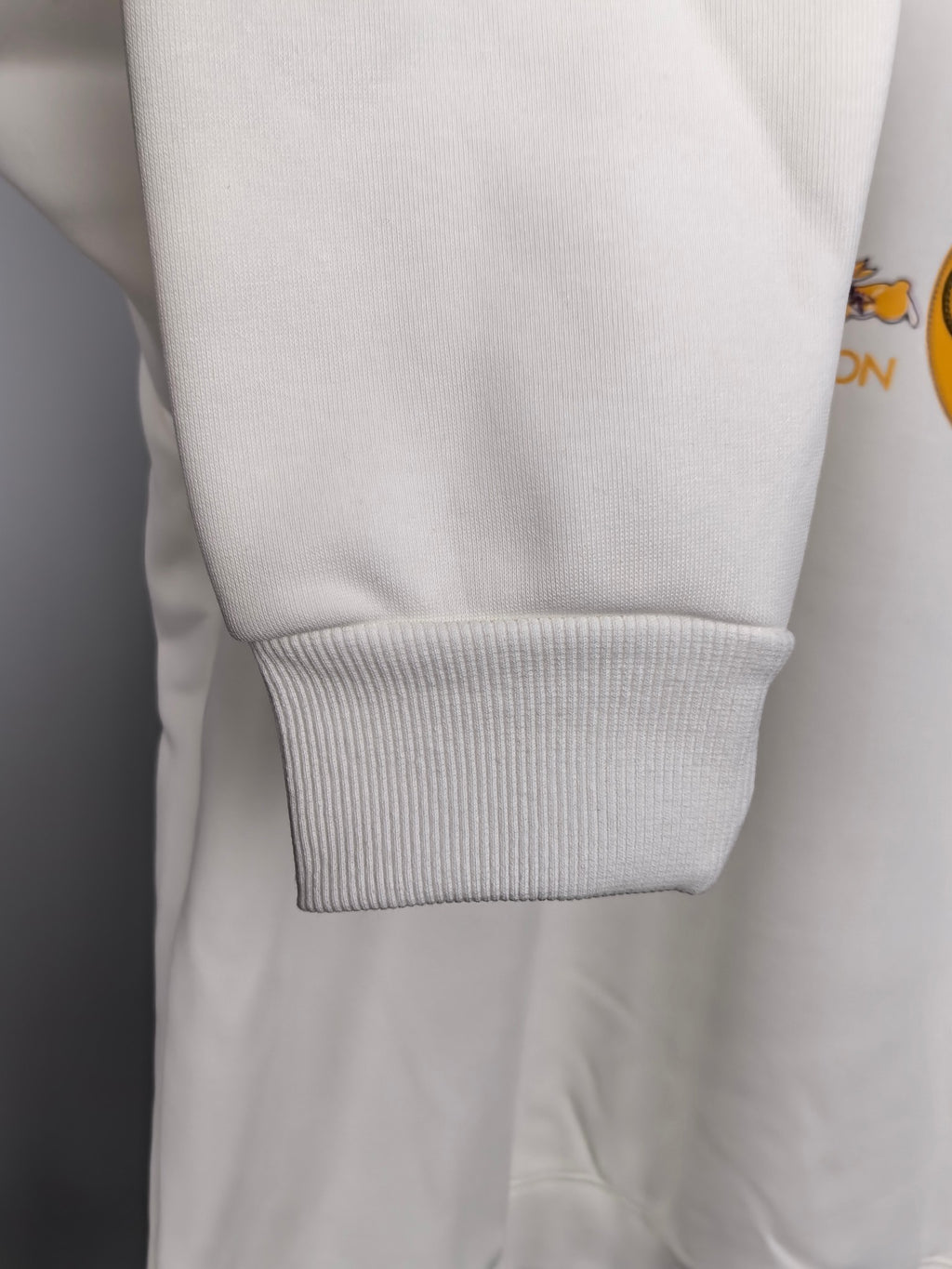 White sweatshirt sleeve with ribbed cuff and ribbed hem