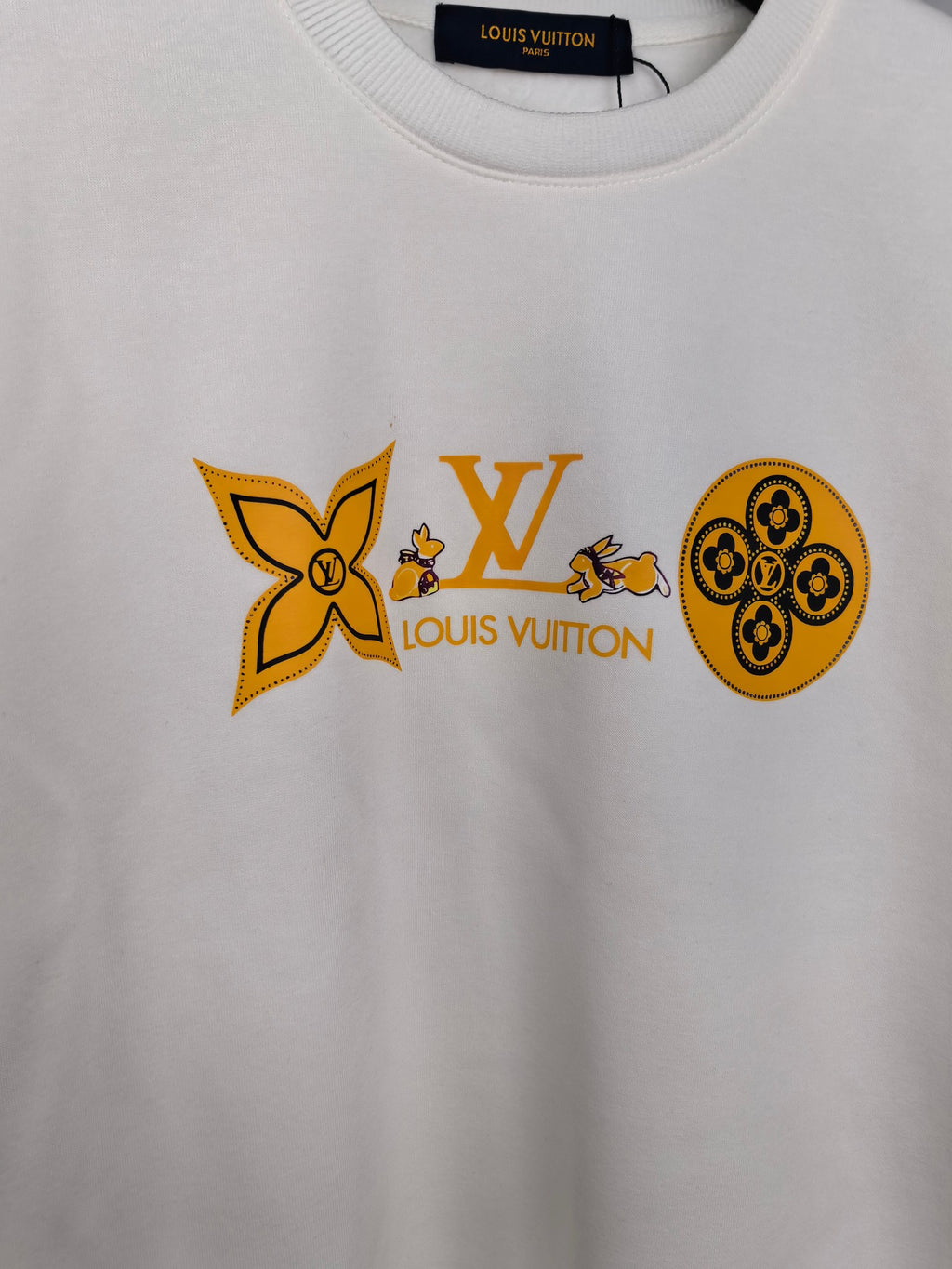 White sweatshirt with orange Louis Vuitton and flower graphic across chest