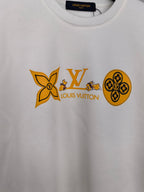 White sweatshirt with orange Louis Vuitton and flower graphic across chest