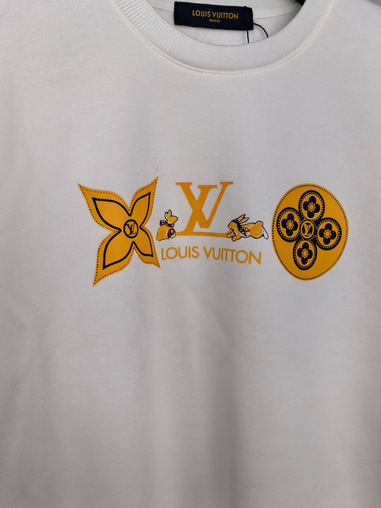 White sweatshirt with orange Louis Vuitton and flower graphic across chest