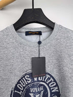 Grey sweatshirt neckline with Louis Vuitton label and Voyage graphic