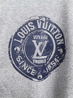 Grey sweatshirt front featuring Louis Vuitton Voyage Trunks circular graphic