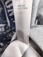 White fabric care tag with Japanese text and “100%”