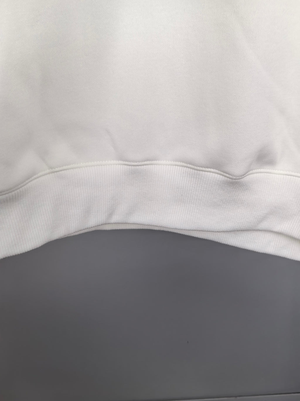 White sweatshirt hem with ribbed waistband trim