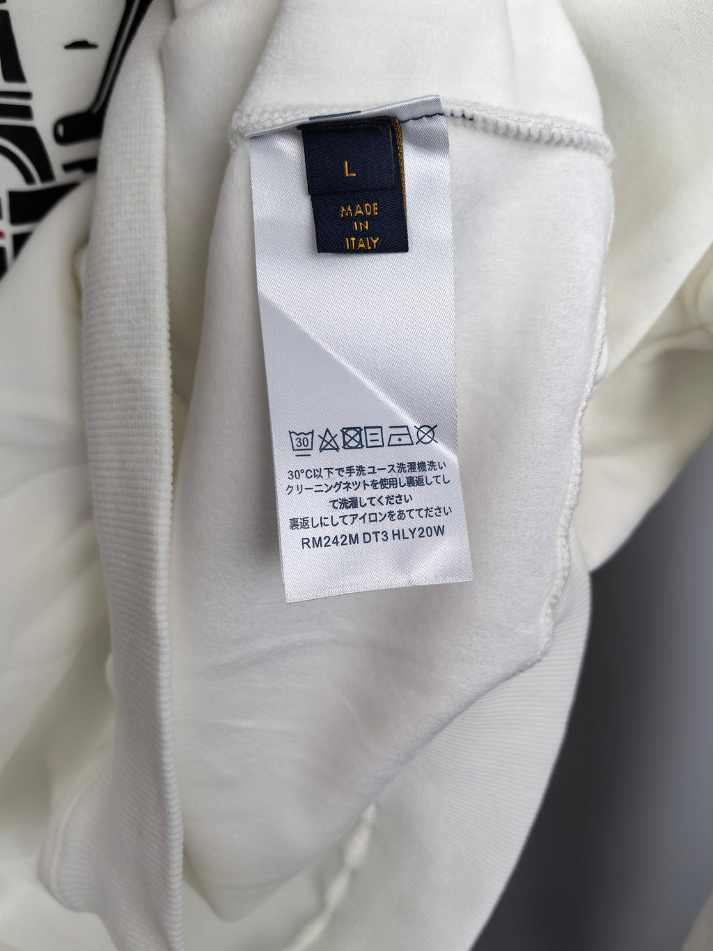 White sweatshirt interior neck label marked "Made in Italy"