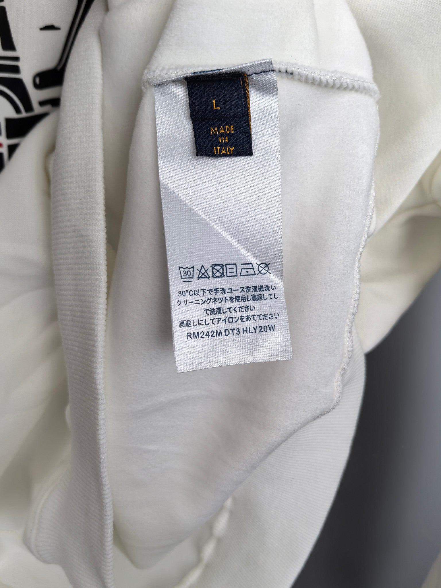 White sweatshirt interior neck label marked "Made in Italy"
