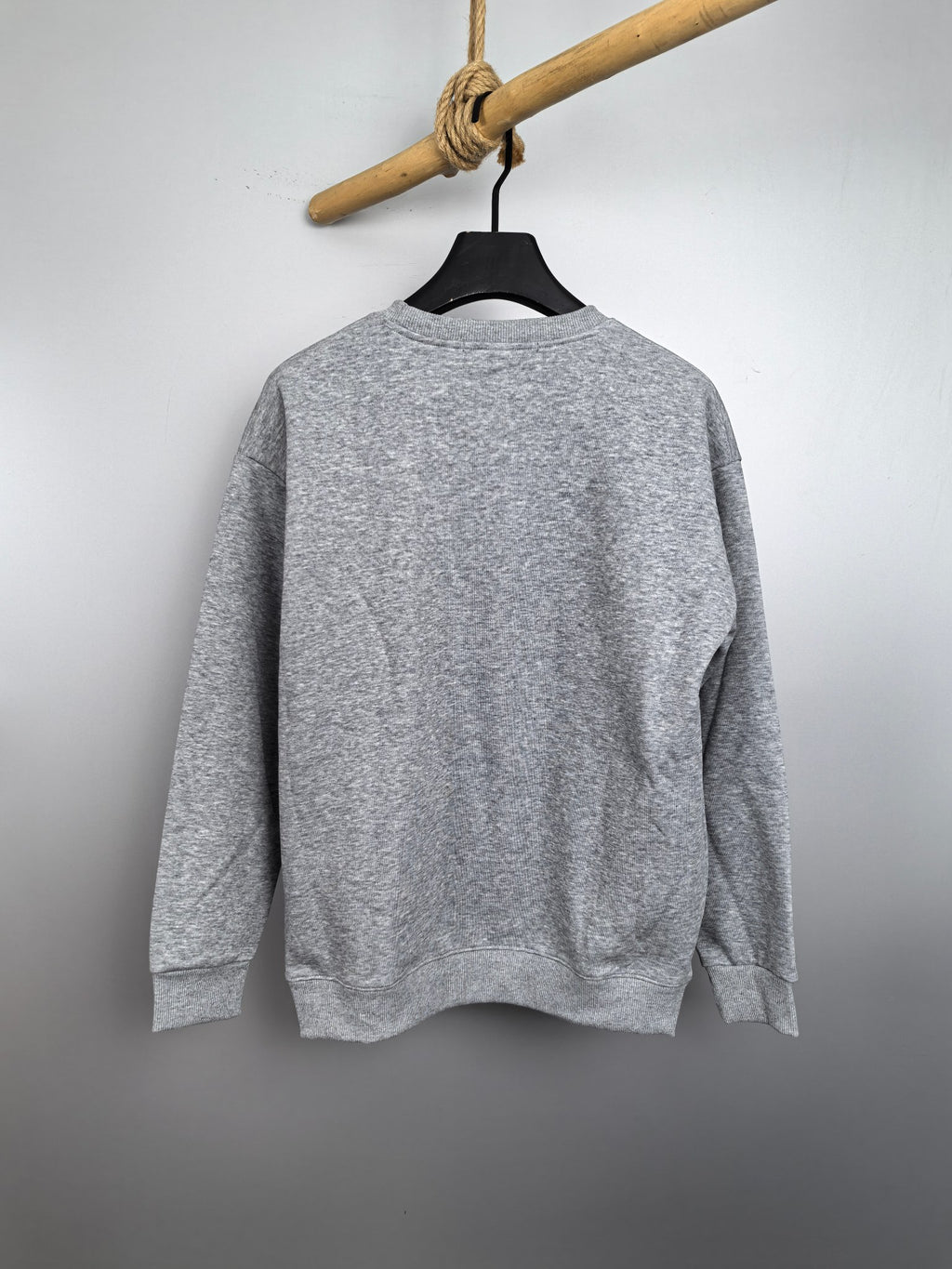 Grey crewneck sweatshirt on hanger, plain back view