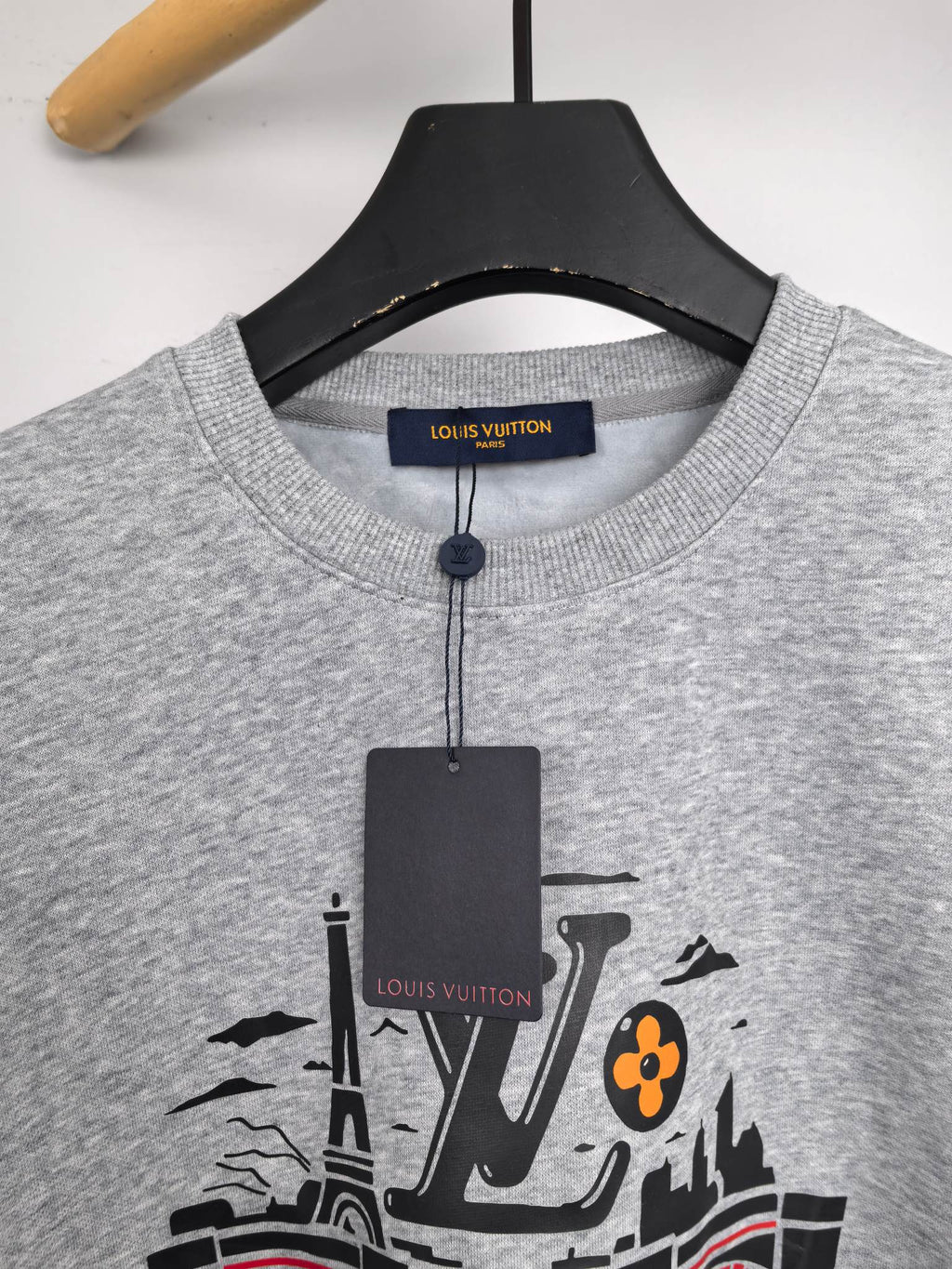 Front view of grey crewneck sweatshirt with printed city and LV graphic