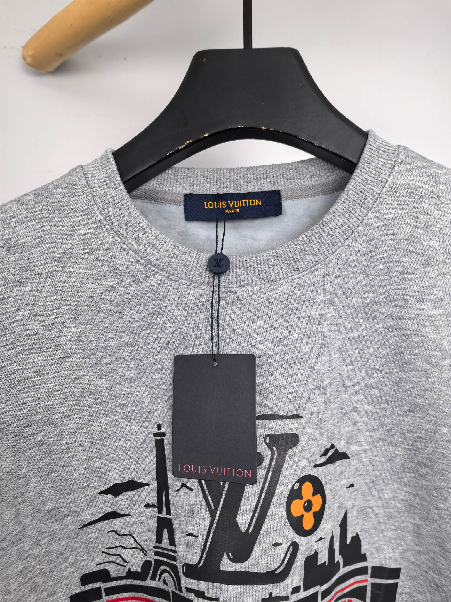 Front view of grey crewneck sweatshirt with printed city and LV graphic
