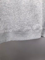 Grey crewneck sweatshirt cuff and lower hem detail