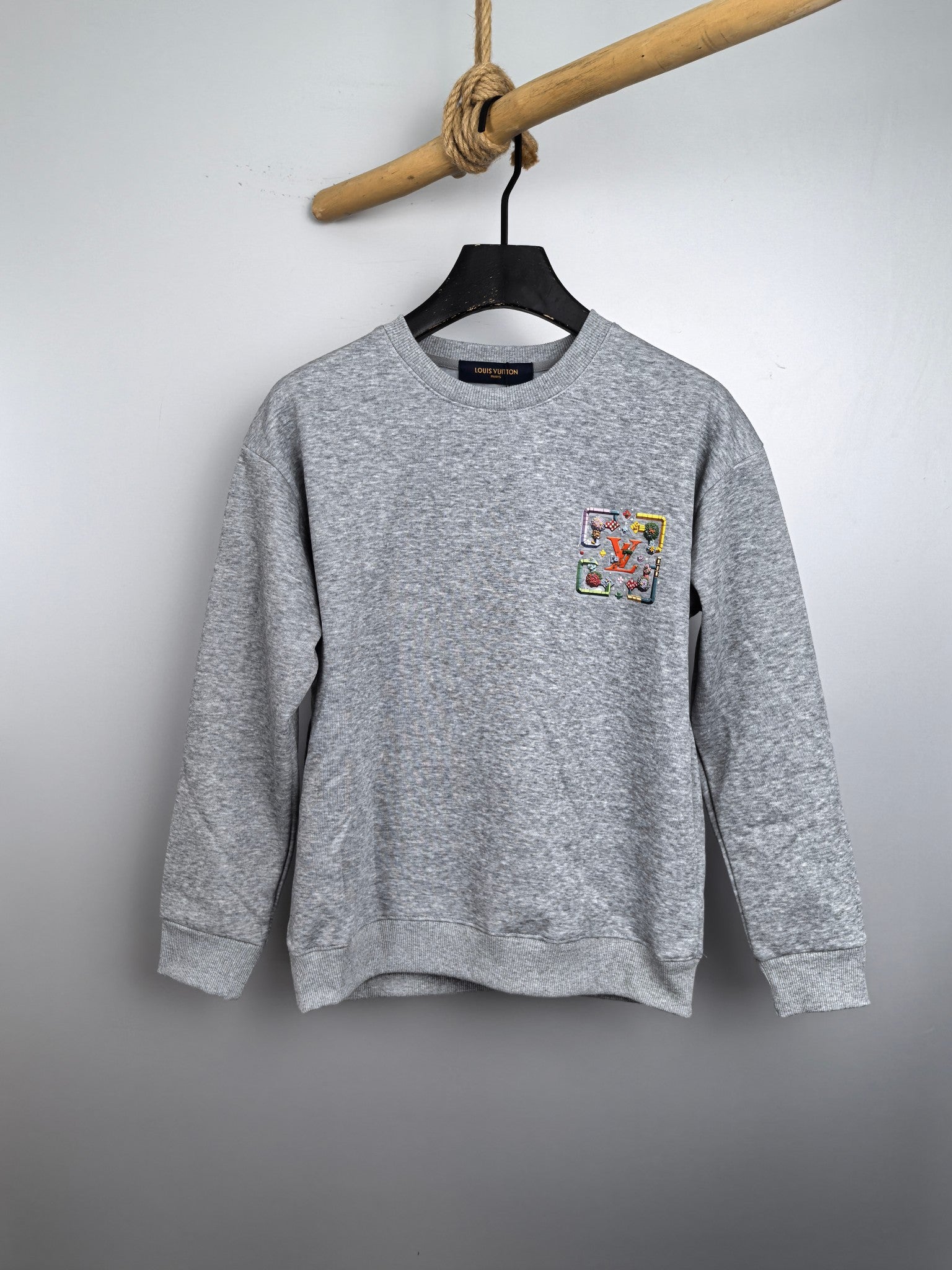 Light gray long-sleeve crewneck sweatshirt with colorful front graphic