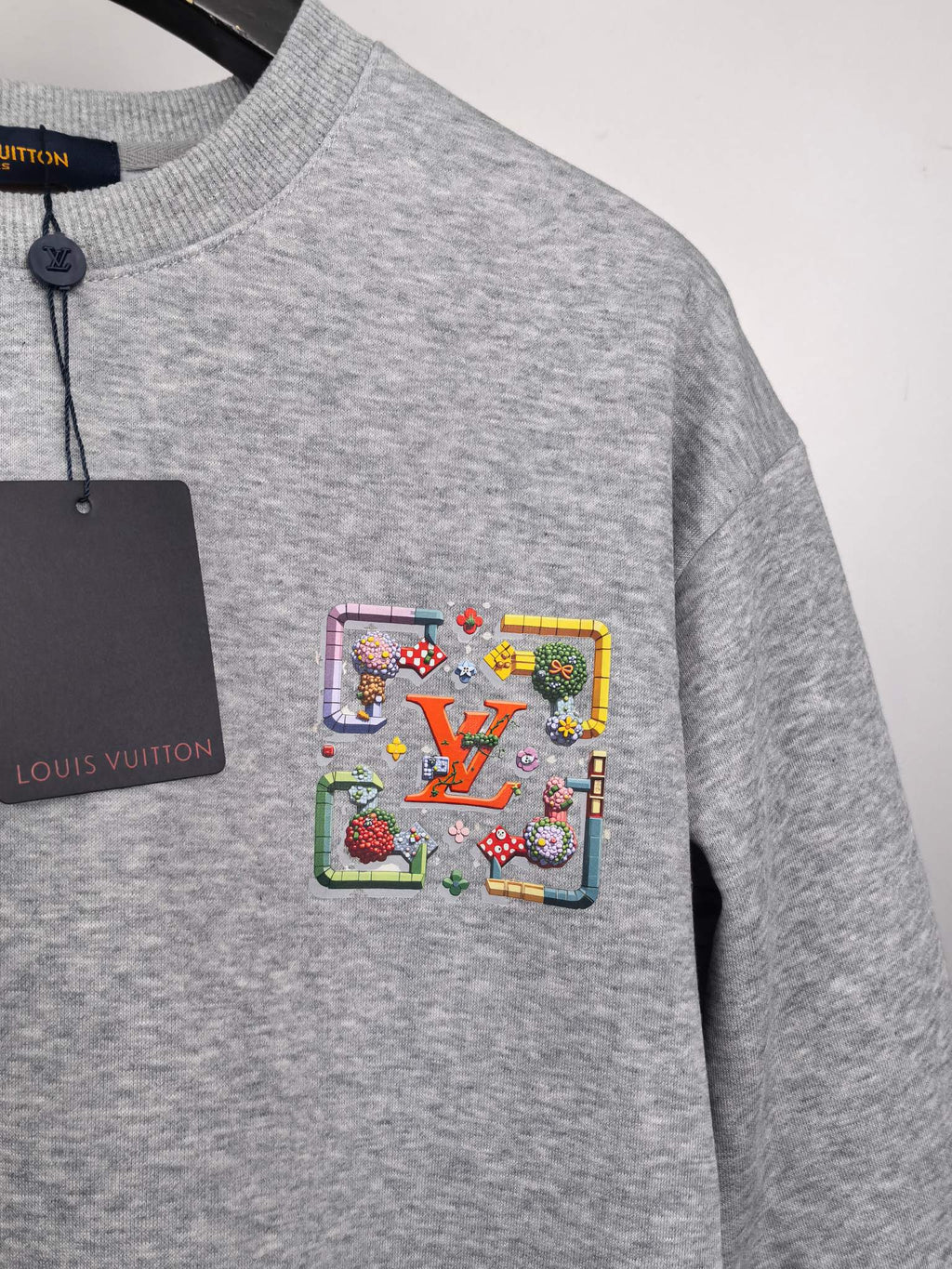 Gray long-sleeve sweatshirt with colorful front crest patch