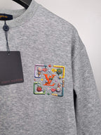 Gray long-sleeve sweatshirt with colorful front crest patch