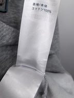 Gray sweatshirt fabric content label showing 100% knit