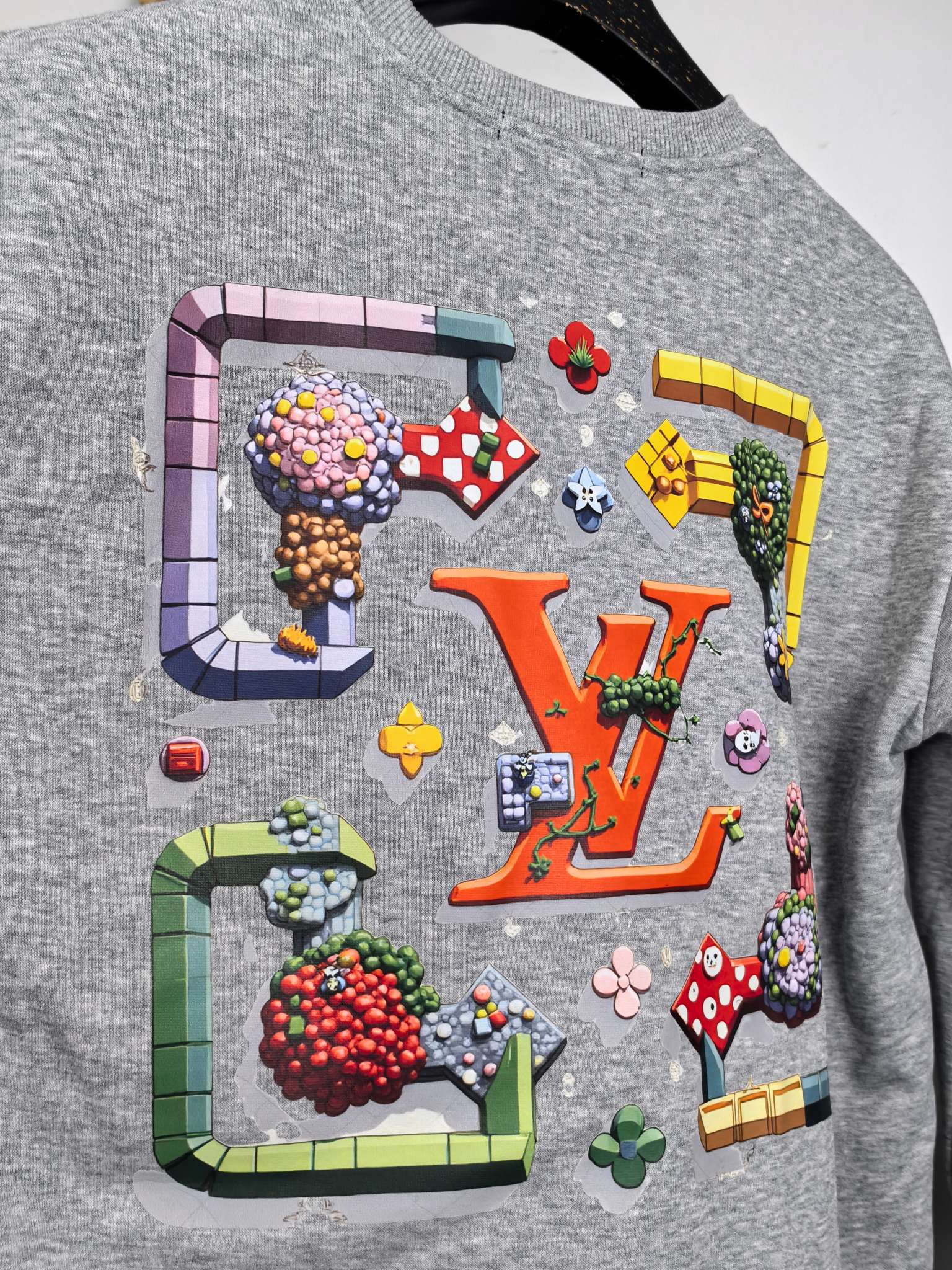 Gray crewneck sweatshirt with multicolor graphic across chest
