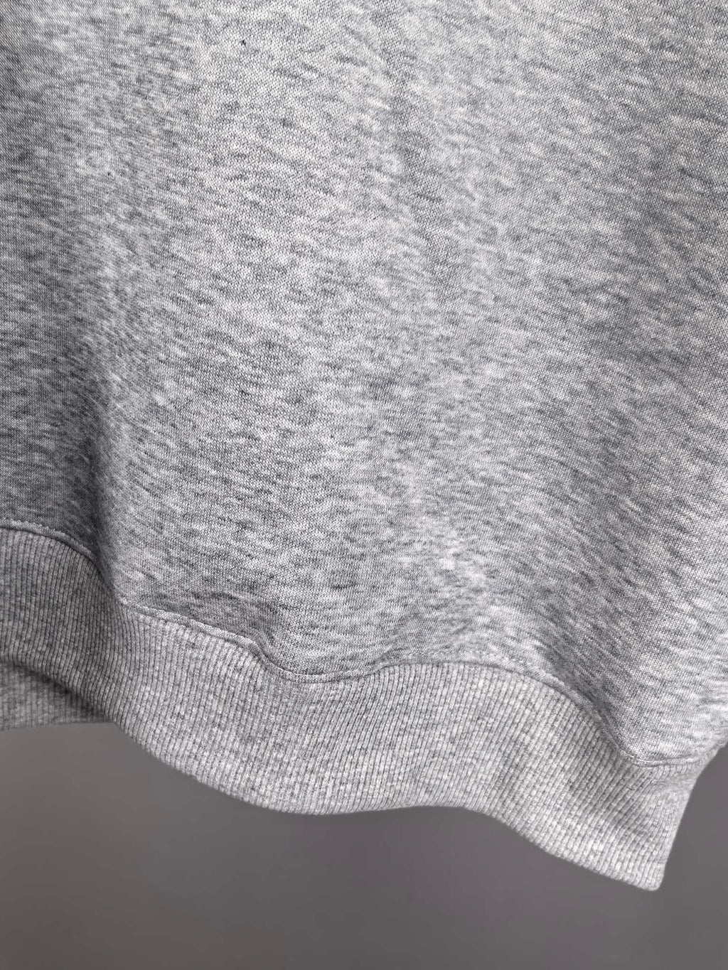 Gray ribbed sweatshirt hem with knit texture