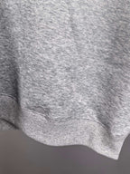 Gray ribbed sweatshirt hem with knit texture