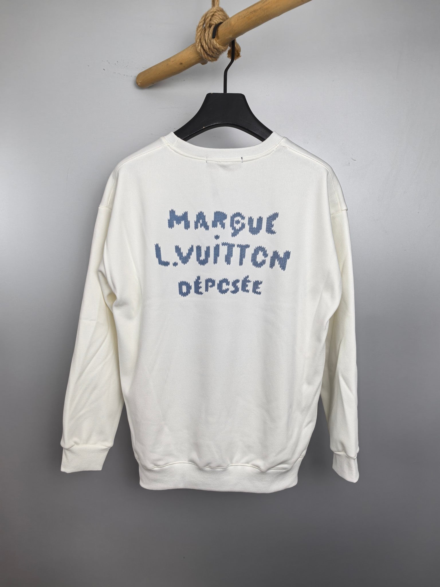 White sweatshirt back with blue "MARQUE LOUIS VUITTON DÉPOSÉ" text