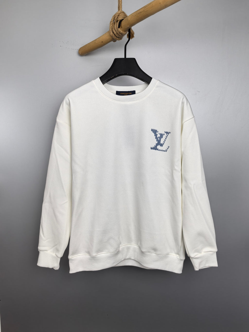 White Louis Vuitton sweatshirt with blue logo graphic at chest