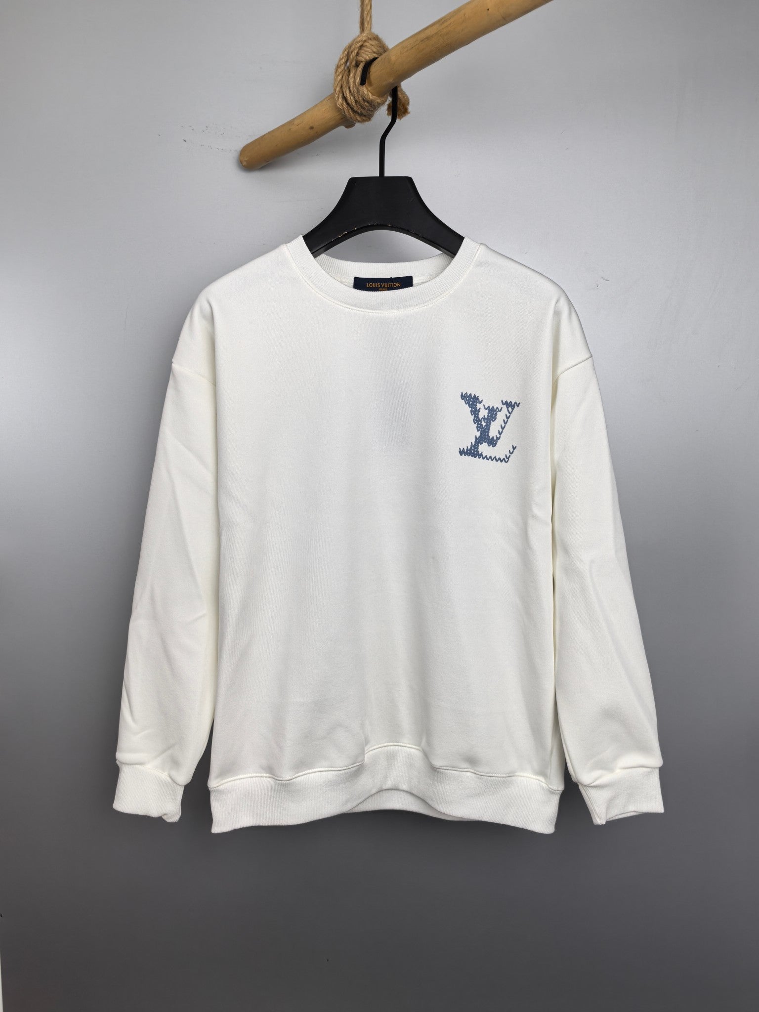 White Louis Vuitton sweatshirt with blue logo graphic at chest