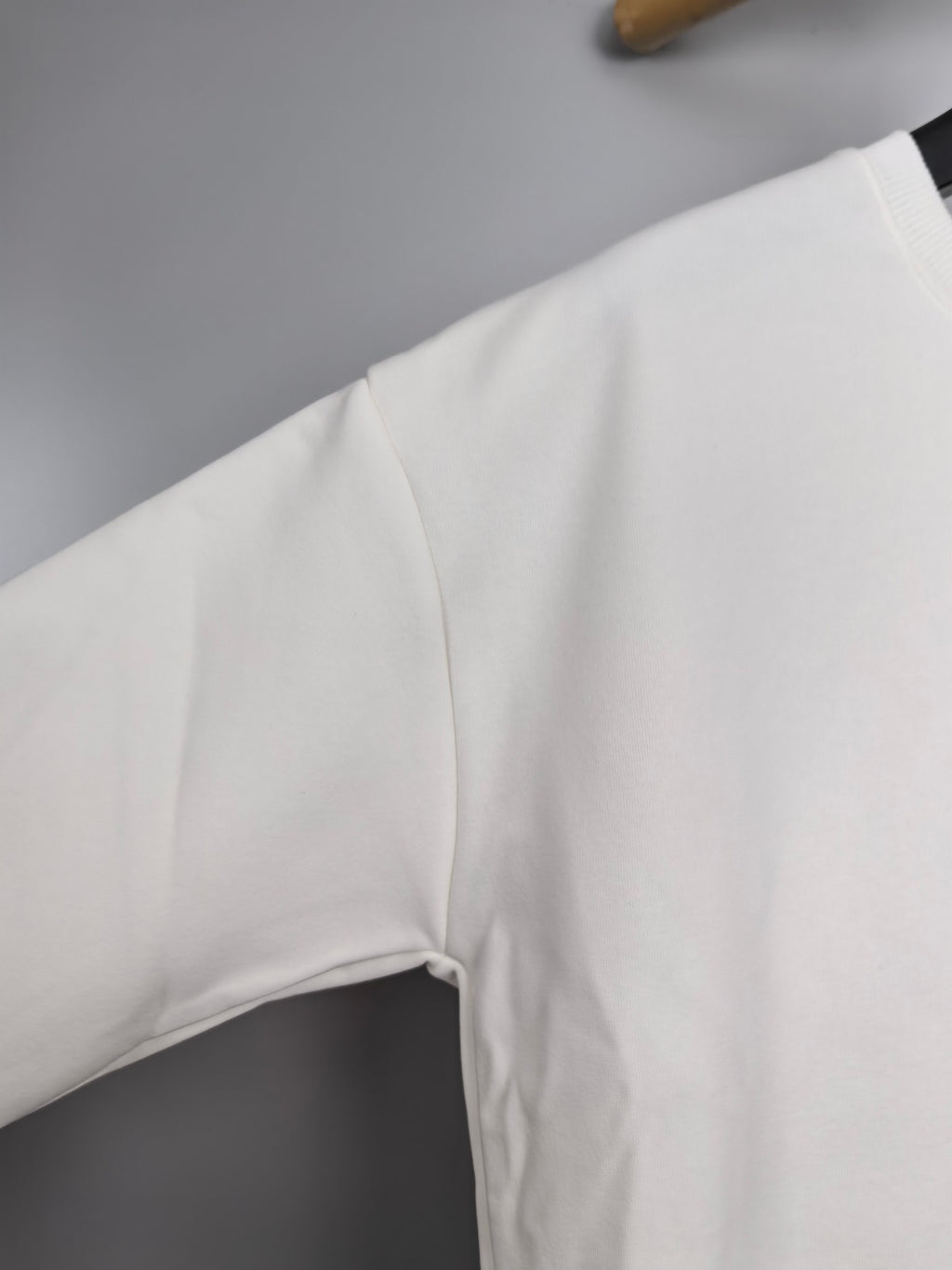 White sweatshirt sleeve and shoulder seam detail