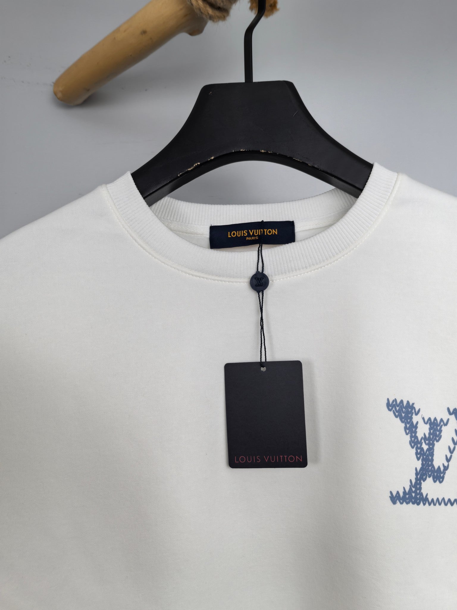 Crewneck sweatshirt collar with Louis Vuitton label tag and blue drawstring detail