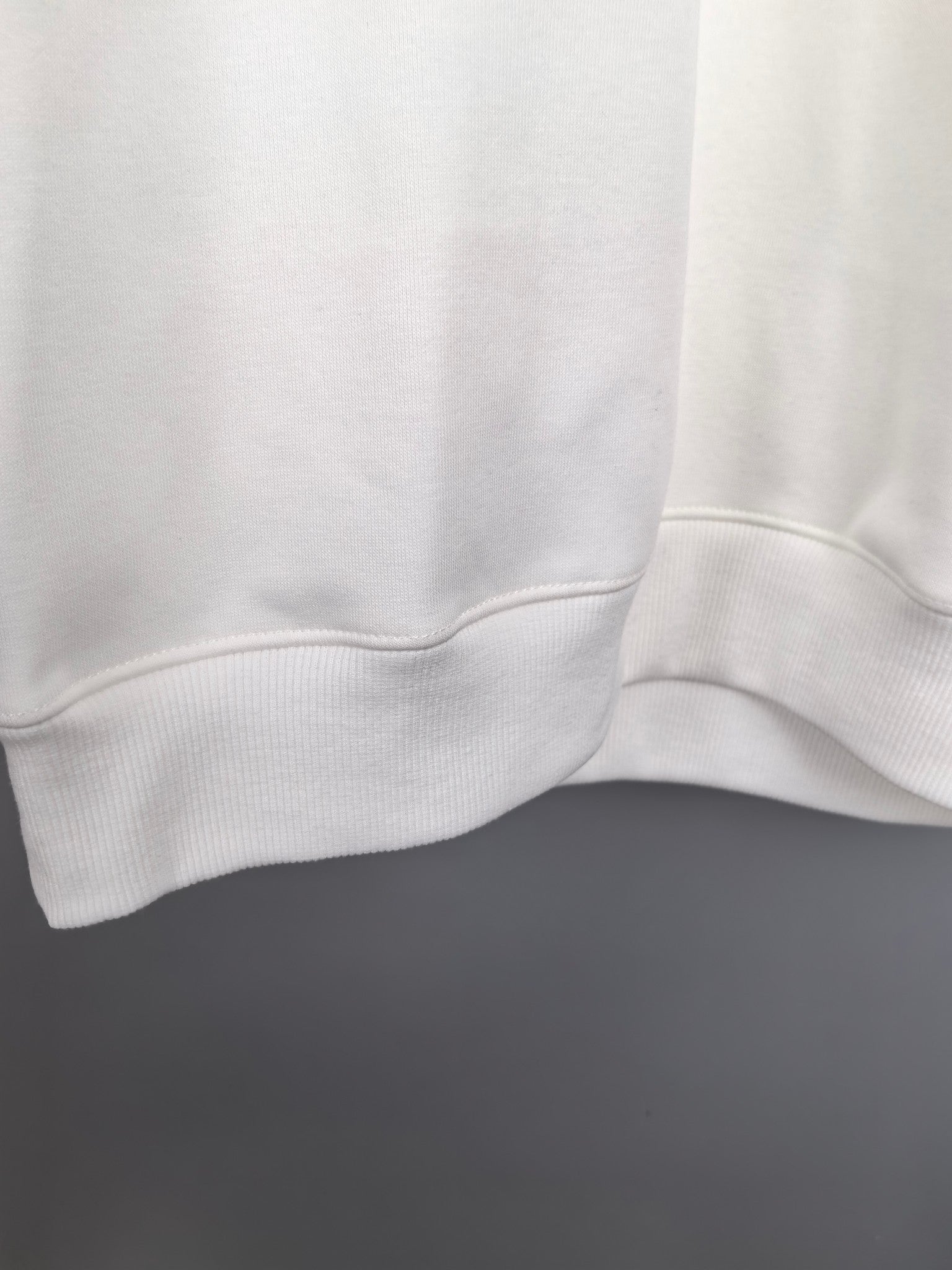 White sweatshirt hem with ribbed trim