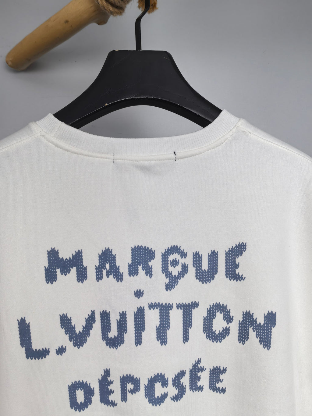 White sweatshirt front with blue "MARQUE LOUIS VUITTON DÉPOSÉ" lettering