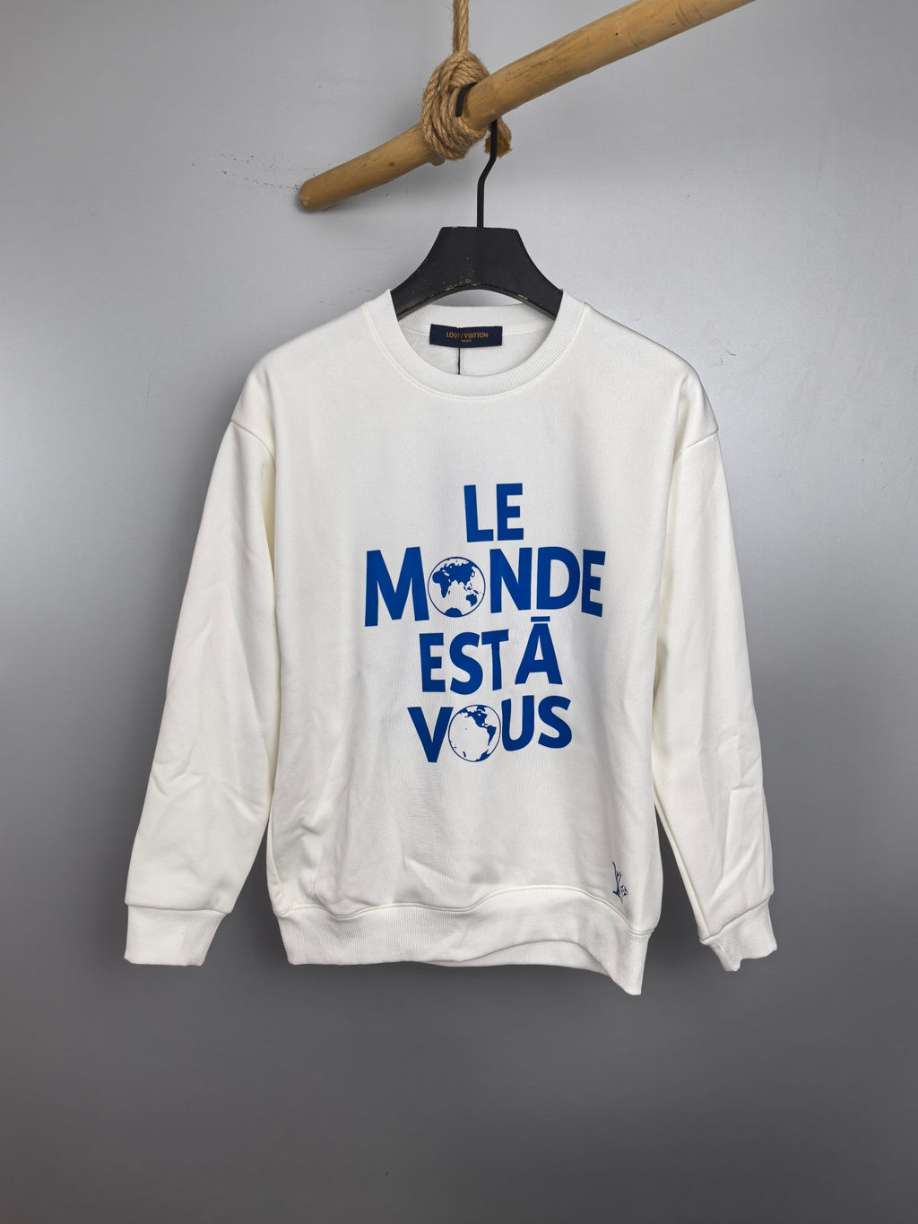 Louis Vuitton long-sleeve sweatshirt, white with blue “LE MONDE ESTÀ VOUS” print