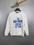 Louis Vuitton long-sleeve sweatshirt, white with blue “LE MONDE ESTÀ VOUS” print