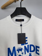 Louis Vuitton sweatshirt neckline close-up with “LE MONDE” blue graphic and tag