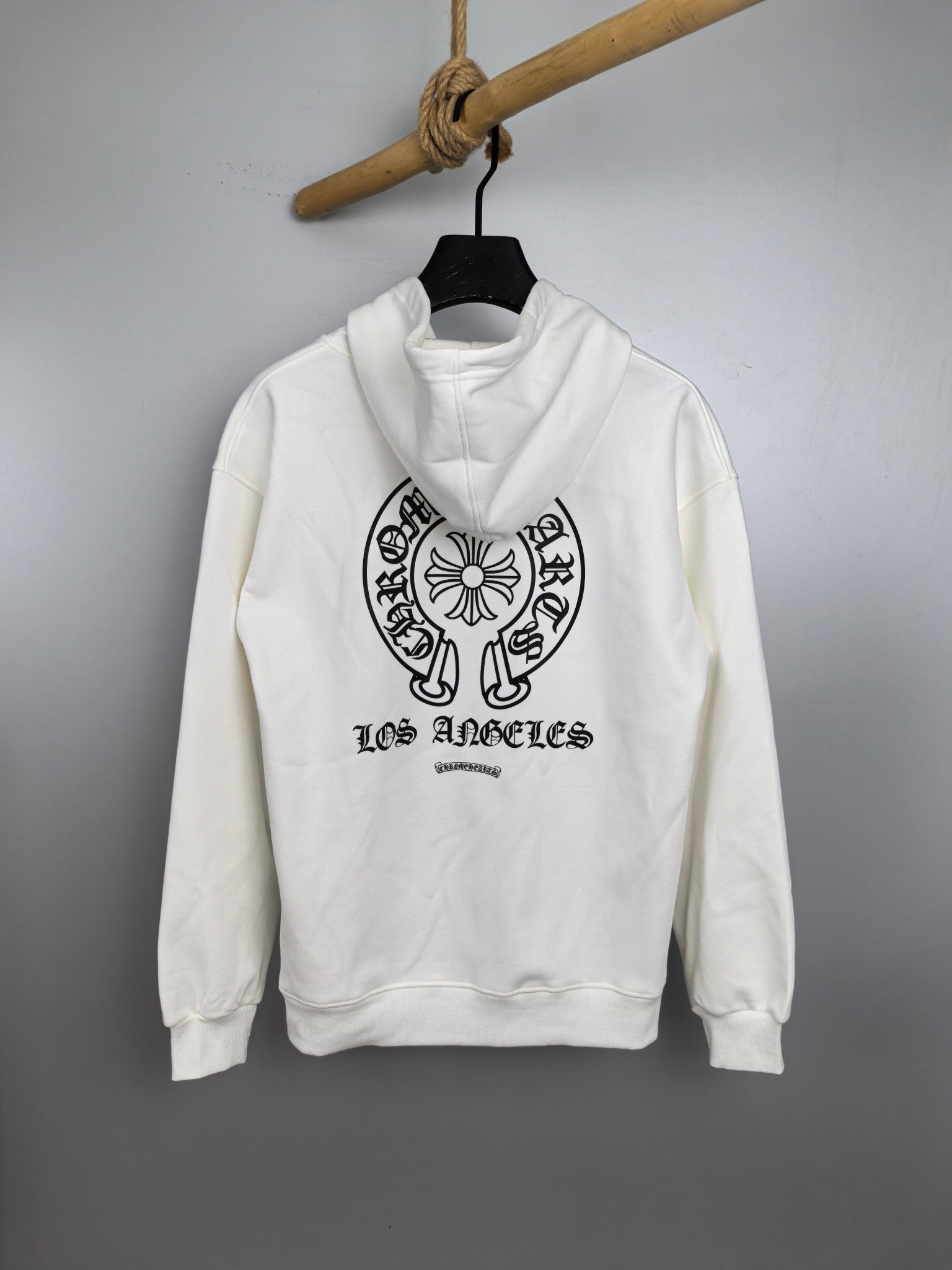 White pullover hoodie with front graphic and “Los Angeles” text