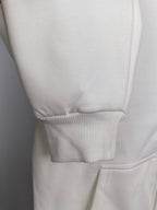 White hoodie hem with ribbed cuffs and stitched seam detail