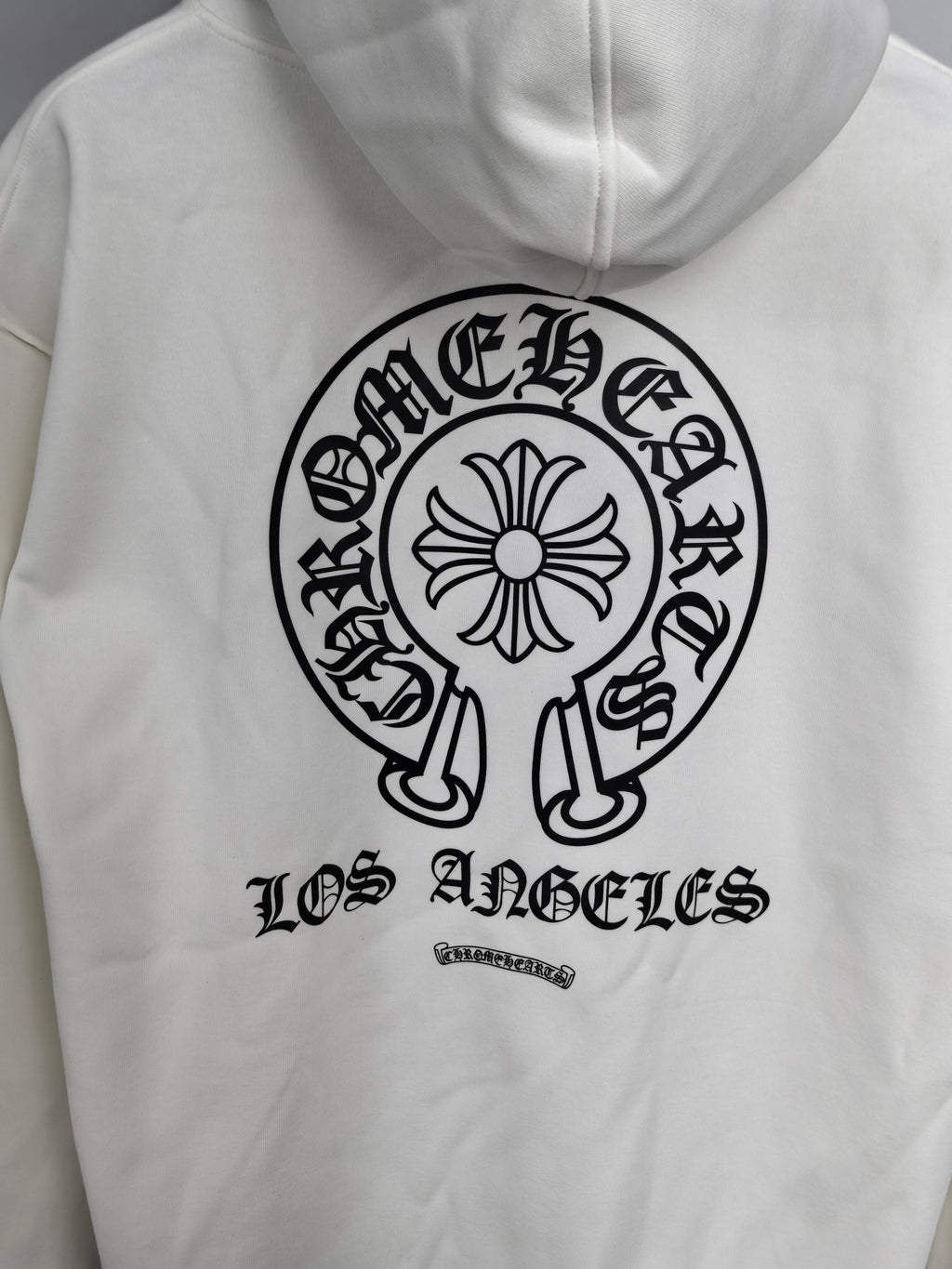 White hoodie front with large circular logo and “Los Angeles” lettering