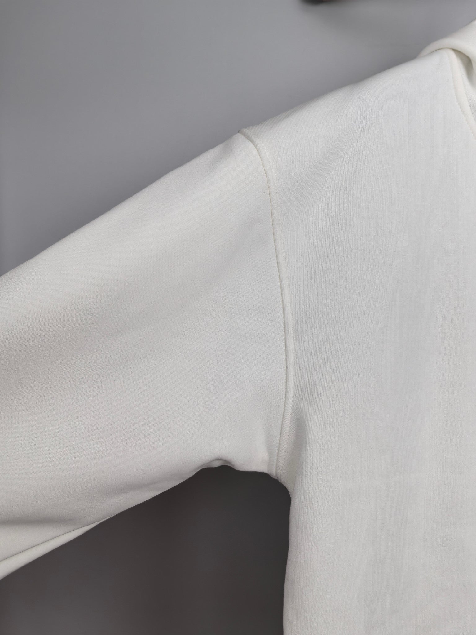 White hoodie sleeve and side seam detail