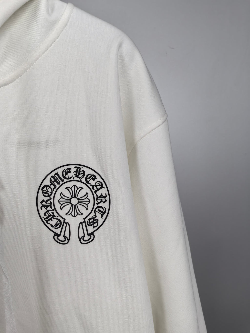 White hoodie with circular logo graphic on the sleeve