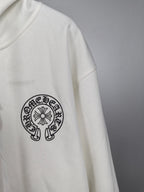 White hoodie with circular logo graphic on the sleeve
