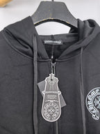 Close-up of black zip-up hoodie hood and metal zipper with hanging tag