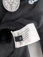 Black zip-up hoodie fabric label tag with cotton content text