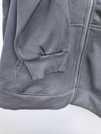 Black zip-up hoodie with front kangaroo pocket and stitched hood