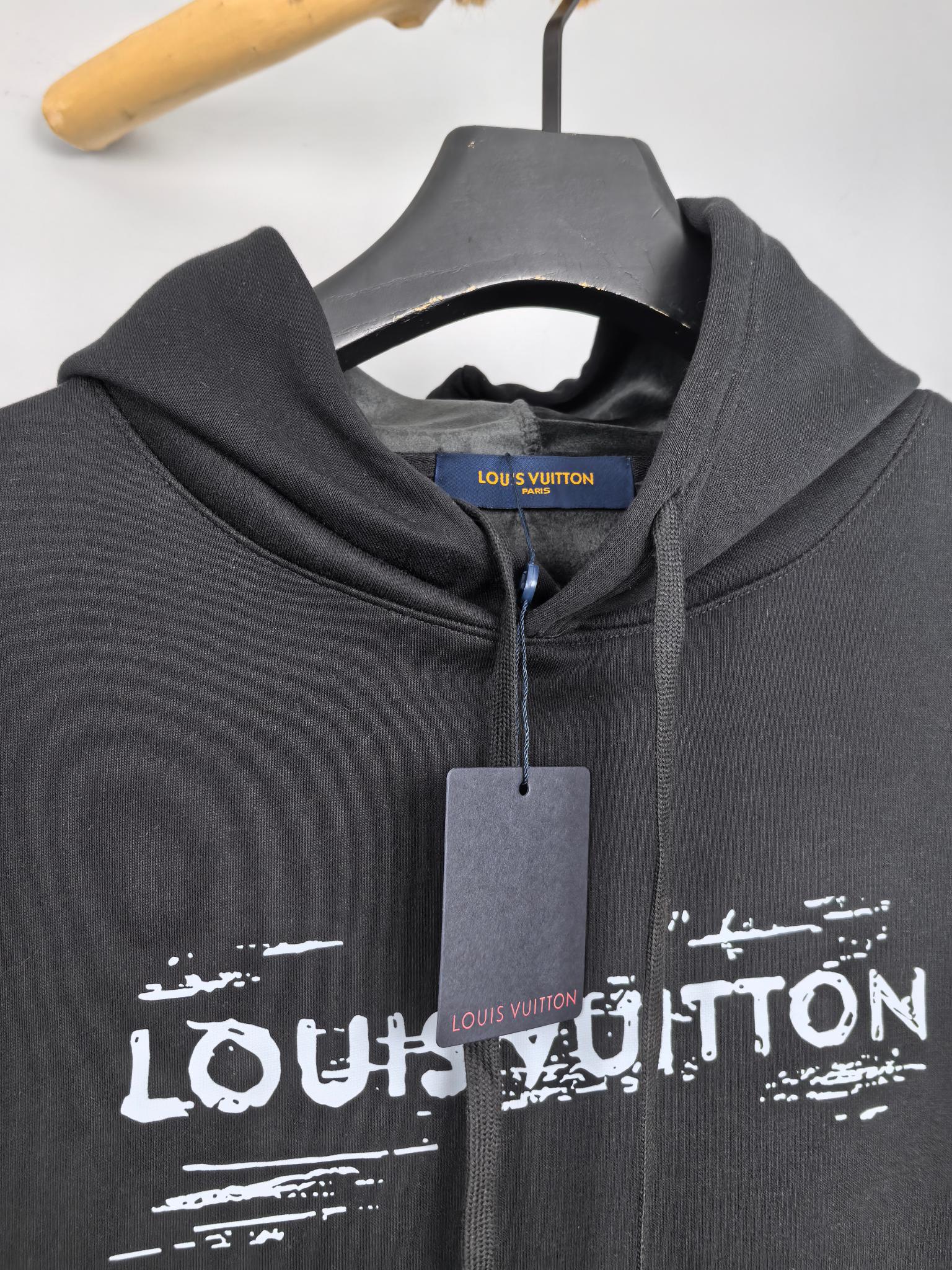 Black hoodie neckline with drawstrings and Louis Vuitton logo print, hanging tag.