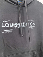 Black hoodie chest with Louis Vuitton logo print and drawstring ties.