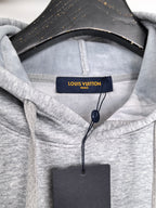 Heather gray hoodie hood with Louis Vuitton Paris tag at the neckline